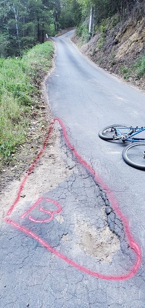 Seems cars cut the corner driving over this dirt area ... then make a nicer transition on the existing asphalt?